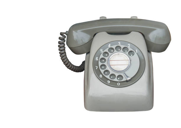 Old vintage phone with wire on wooden shelf, retro design close-up nostalgia elderly