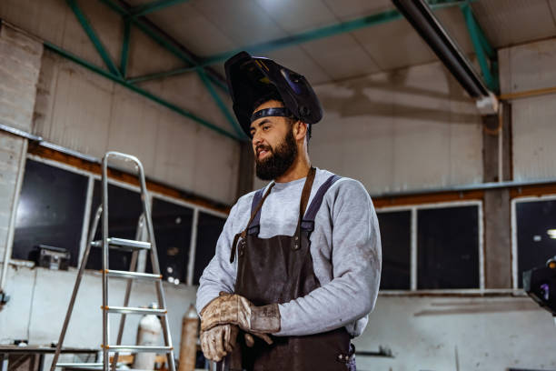 istock Smiling worker at metal manufacturing plant. 1358926702