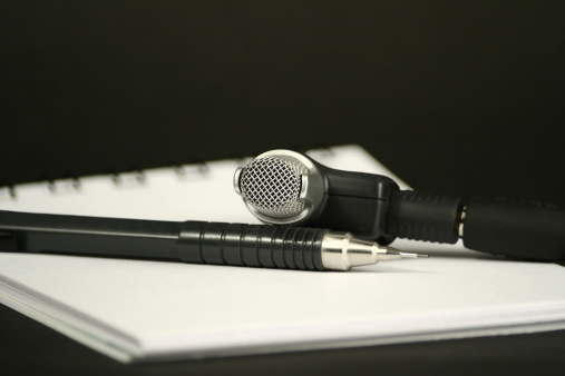 microphone, pencil and note pad