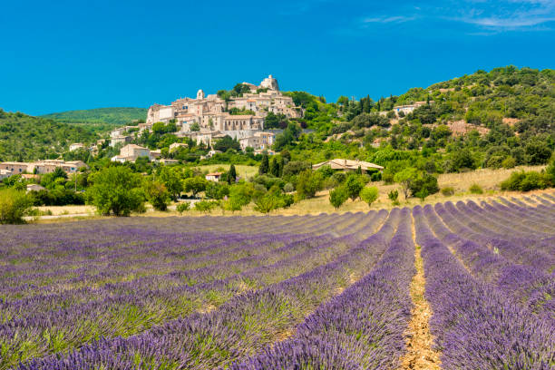 Simiane-la-Rotonde town in France Small but beautiful old town of Simiane la Rotonde with a lavender field in front of it, Provence - France france village blue sky stock pictures, royalty-free photos & images