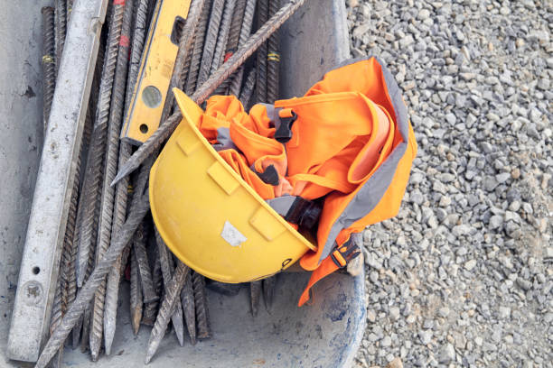 Shovel and hard hat on soil. Home construction and renovation