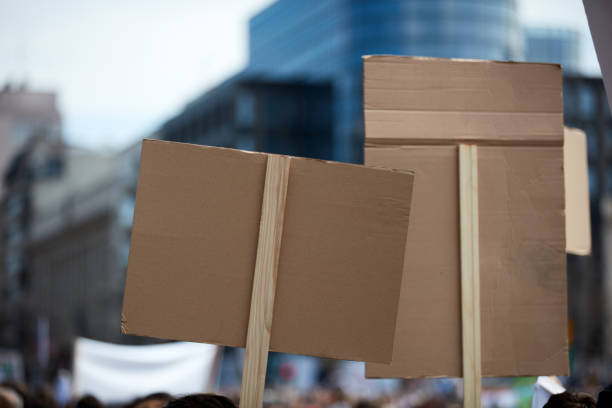istock Protesters holding placards and signs on the streets. 1358927988