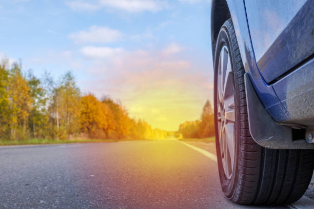 istock a car wheel on an asphalt road 1358928786