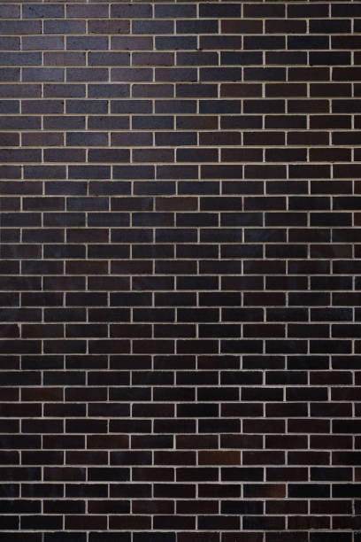 istock Part of a dark brick wall 1358929191