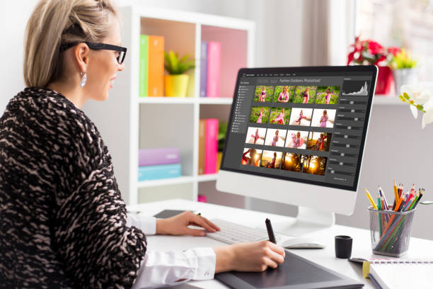 istock Woman working with digital photo library on desktop computer and editing photos 1358931236