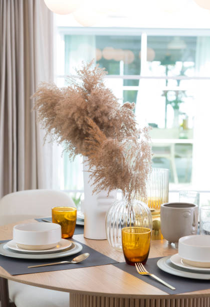 istock Table set on round table in modern style dining room interior of modern home. 1358931402