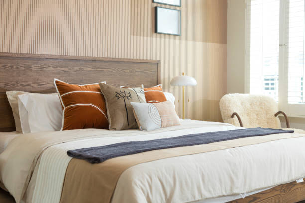 istock Red and brown tone pillow in modern bedroom with blank picture frame on wall. 1358931414
