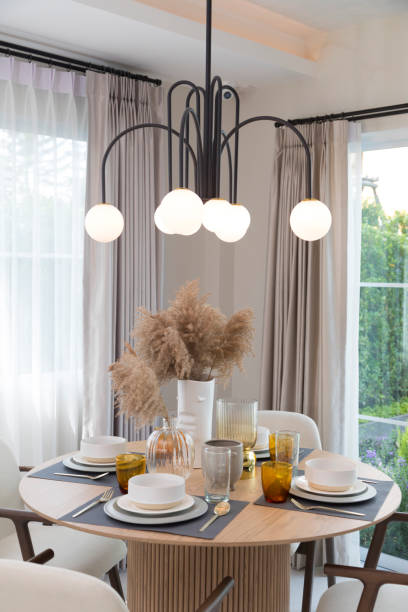 istock Table set on round table in modern style dining room interior of modern home. 1358931420