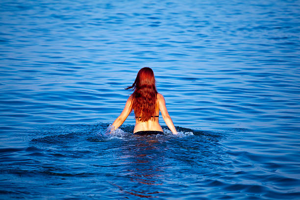 istock Young woman relaxing in sea 135893278