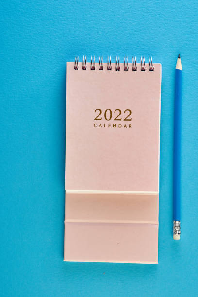 istock desk calendar and pencil on blue background 1358933041