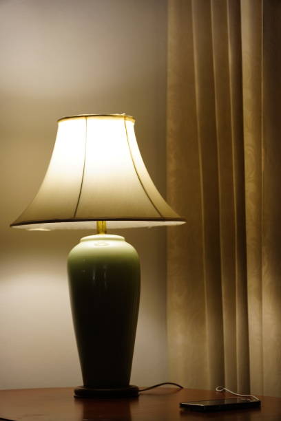 istock Classic lamp on wooden table 1358933831