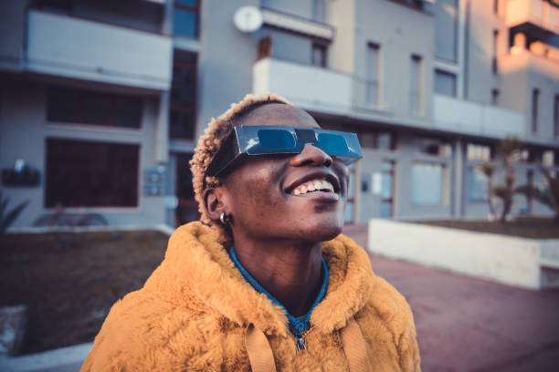 istock Teenage girl looking at solar eclipse 1358933890