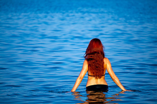 istock Young woman relaxing in sea 135893405