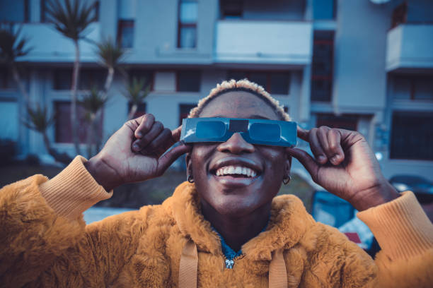 istock Teenage girl looking at solar eclipse 1358934357