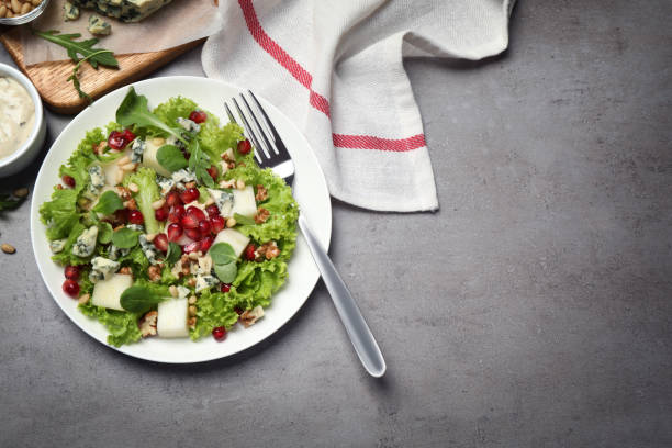 istock Fresh salad with pear served on grey table, flat lay. Space for text 1358937399