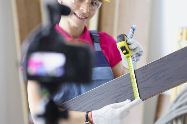 istock Smiling woman construction site worker measure plank with tape measure tool 1358937509