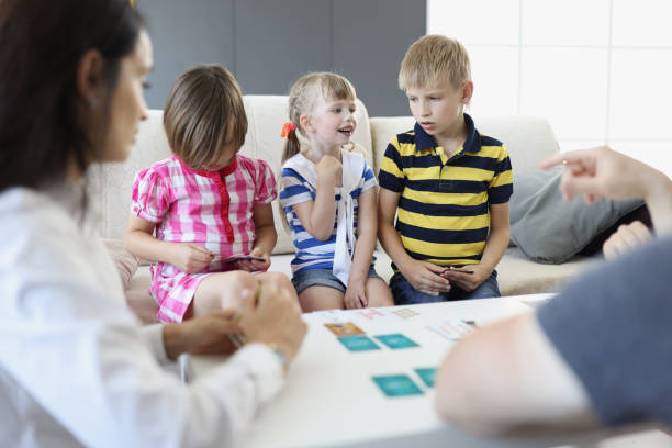 istock Children decide who goes next, playing card game with parents at home 1358937543