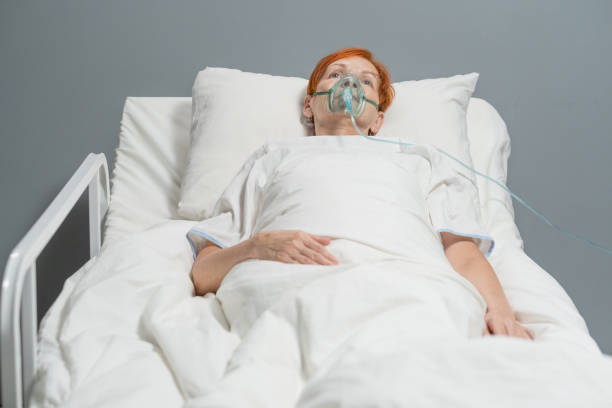 istock Elderly woman breathing with oxygen mask 1358938865