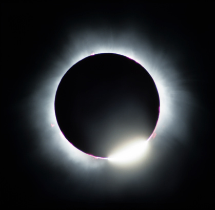 The diamond ring effect is a feature of total solar eclipses. Just before the sun disappears or just after it emerges from behind the moon, the rugged lunar limb topography allows beads of sunlight to shine through.