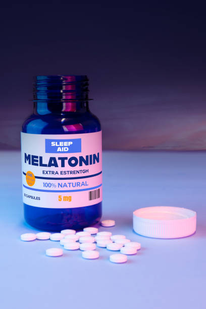 istock bottle with melatonin pills or food supplements, medicine 1358940410
