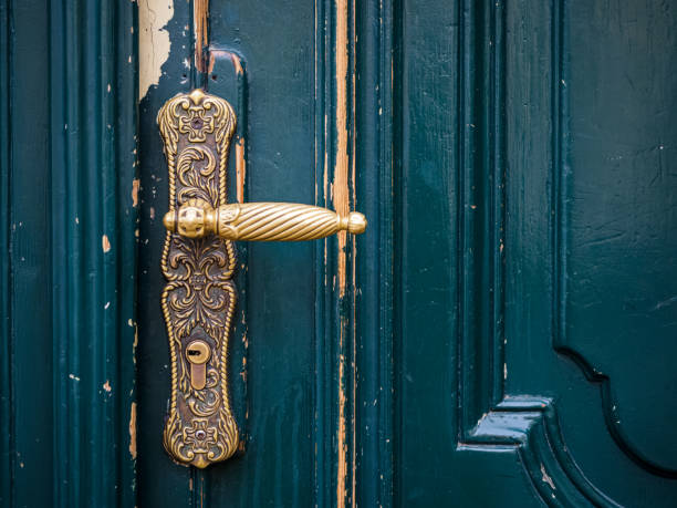 widok z bliska na mosiężną klamkę i stare zielone drewniane drzwi - doorknob zdjęcia i obrazy z banku zdjęć