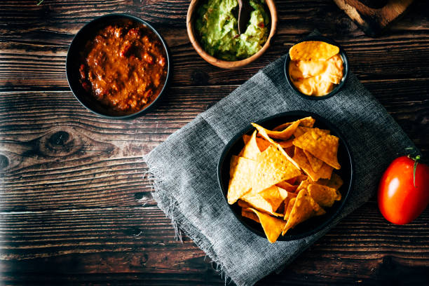 istock Mexican nachos with guacamole, cheddar cheese and chili. 1358940897