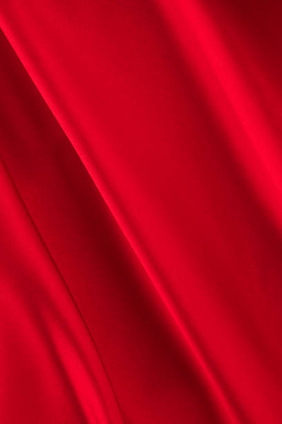 istock draped red silk fabric of satin weave, texture, background 1358941535