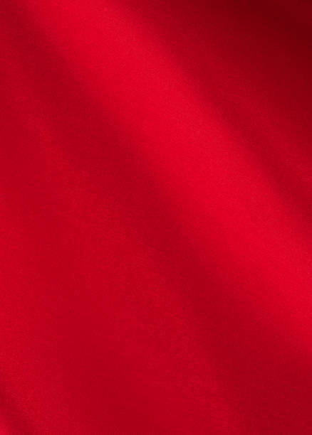 istock draped red silk fabric of satin weave, texture, background 1358941551