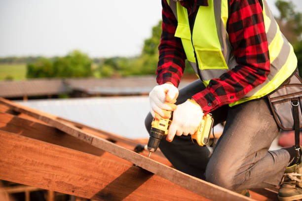 istock Builders in work clothes install new roofing tools, roofing tools, electric drill and use them on new wooden roofs with metal sheets 1358942945