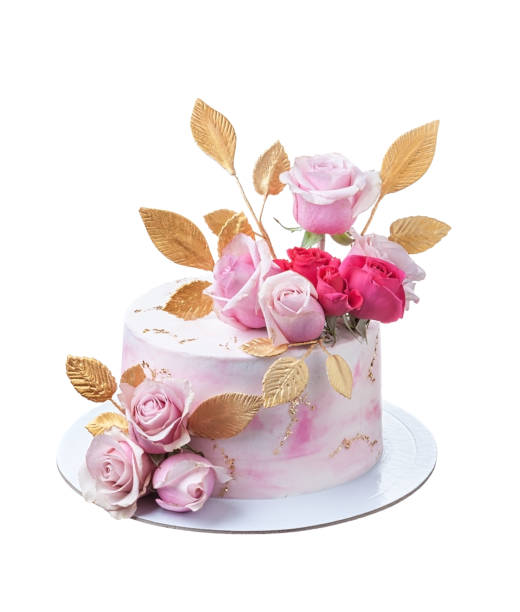 Delicate festive pink cake with rose flowers decorated with golden leaves. Isolated on a white background.