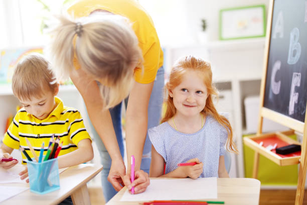 istock Teacher and children in classroom in the elementary school 1358945371