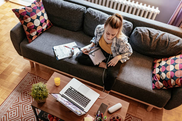 istock Young woman working on laptop at home 1358946664