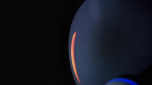 Young man looking at breathtaking view. Space reflecting in helmet visor. Close up on eyes