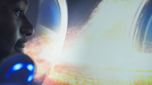 Young man looking at breathtaking view. Black Hole reflecting in helmet visor. Close up on eyes