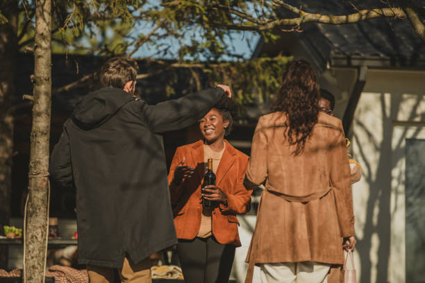 istock Friends embracing and greeting when coming as guests 1358948372