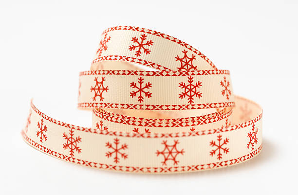 Christmas red ribbon with white snowflakes isolated.