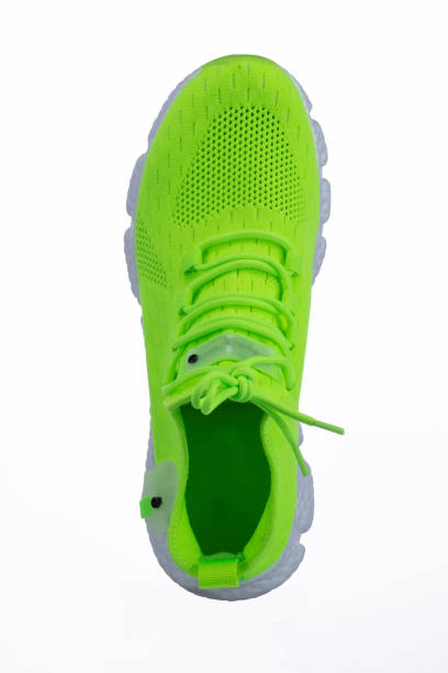 istock Green sneaker made of fabric on a white background 1358949915