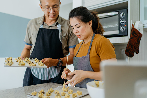 Image of an Asian Chinese couple making cookie dough and prepare for cookie baking