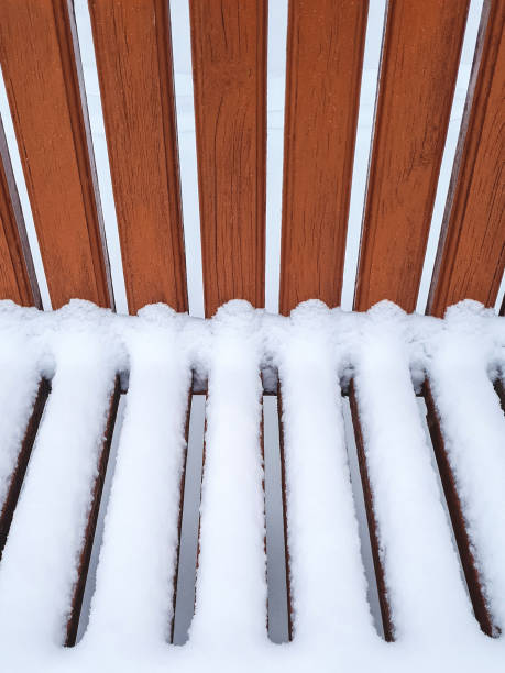 istock Parallel narrow painted boards and snow covered with snow 1358951104