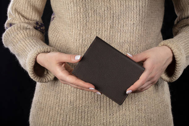 istock A brown leather wallet is in women's hands. 1358952245