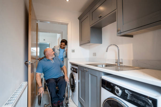 We Love it! A mature couple looking around a new home in Northumberland, they are considering buying it. The house is incomplete and ready for renovation by the buyers. The man is a wheelchair user. looking around stock pictures, royalty-free photos & images