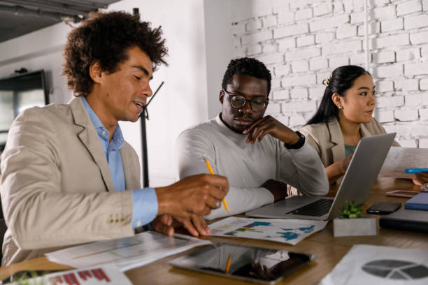istock Business people reviewing a document during a meeting 1358953540
