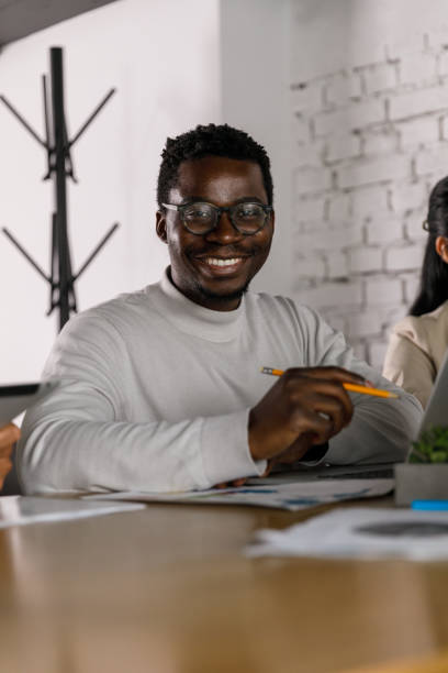 istock Handsome young businessman smiling at camera 1358953547