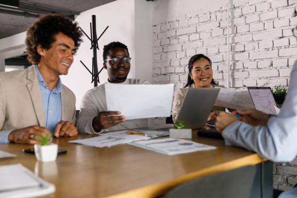 istock Business people reviewing various documents during a meeting 1358953553