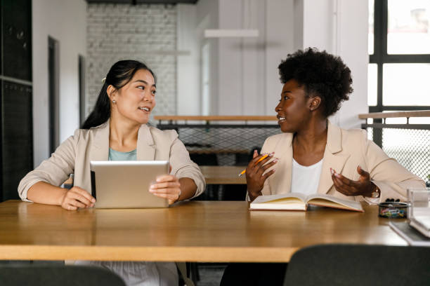istock Two businesswomen teaming up and brainstorming ideas for a project 1358954353