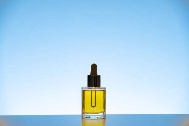 istock Face oil on blue background 1358954636