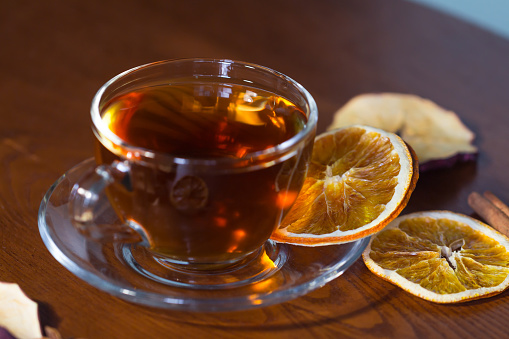 Cup of tea and slices of dried orange, autumn