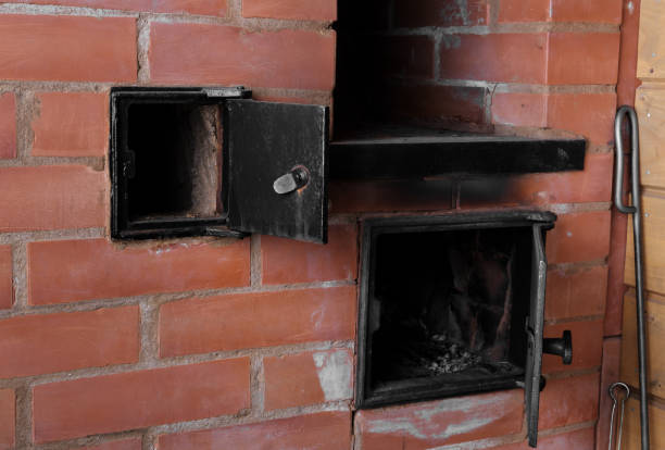Fire in an open fireplace is being turned on with the dry kindling wood.