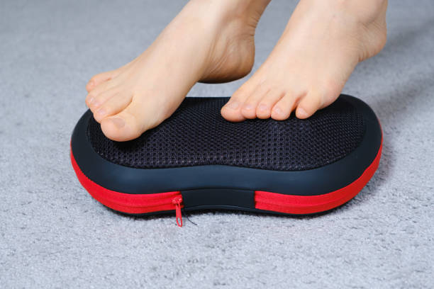 istock Women's feet on a massage pillow, relieving leg fatigue after a day's work. 1358956548