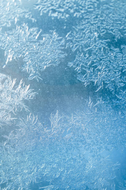 istock A magical ice patterns on a frost window in blue color scheme 1358958984